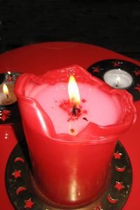 961321_red_candle_on_plate.jpg