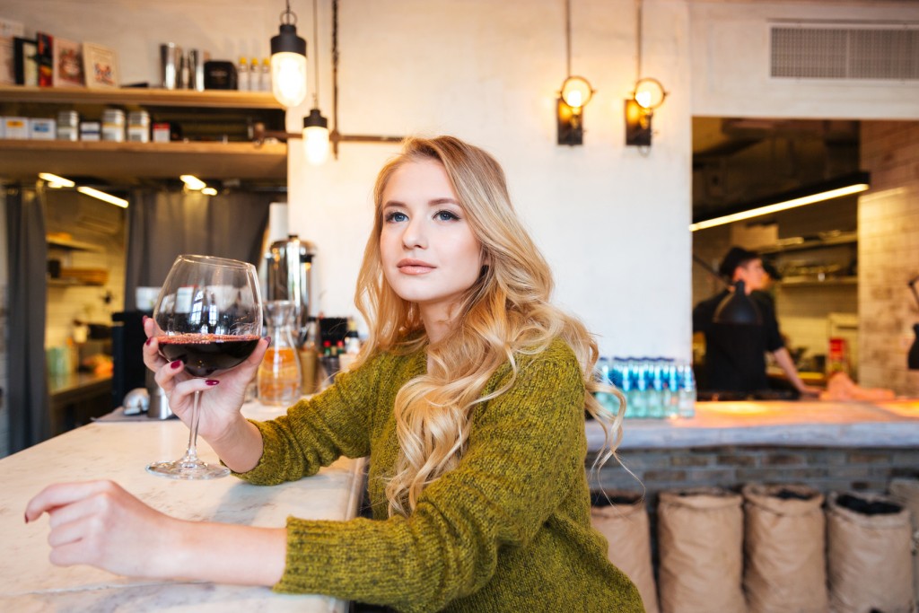 Beautiful woman drinking wine in restaurant